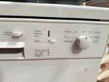 an image of a white dishwasher with buttons on it