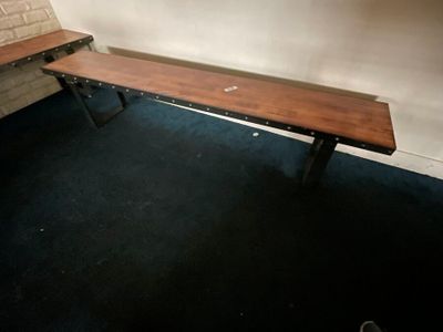 a wooden bench in the corner of a room