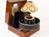 a wooden box with a clock on it and a lamp on top