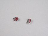 pair of red and silver earrings on a white surface
