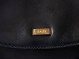 a close up of a black bag with a gold label on it