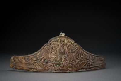 an image of a wooden sculpture of a boat with people on it