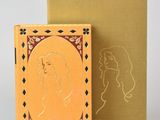 a book with a picture of a woman on it next to a box