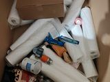 a cardboard box filled with toilet paper and other items