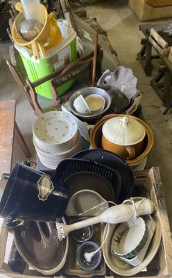 pile of dirty dishes and pans sitting on top of a wooden box