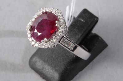 an image of a ring with a ruby stone and diamonds