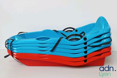 several blue and red kayaks stacked on top of each other