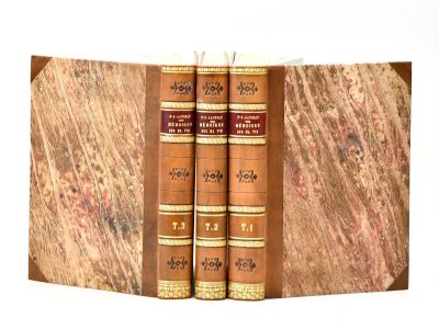 two books that are sitting on top of a book case