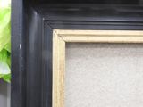 a picture of a picture frame on a shelf next to a plant
