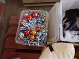 a dog that is sitting in a box with christmas ornaments