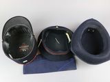 three hats sitting on top of a blue cloth