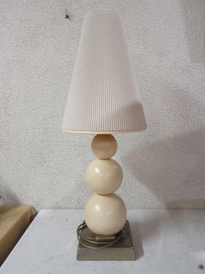 a lamp that is sitting on a table with a lamp shade on it