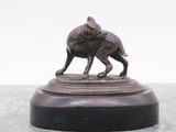 a bronze statue of a dog and a cat on a pedestal