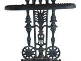 an old cast iron cross on a wooden stand on a white background