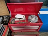 a red tool box with tools in it sitting on the floor
