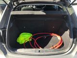 an open trunk of a car with a hose in it