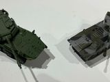 two toy tanks that are on display on a table