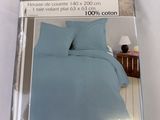 the box of a bed with a blue comforter and two pillows
