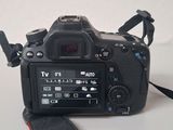 a camera strap attached to a camera on a white table