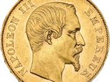 a close up of a gold coin with a man ' s face on it