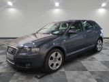a picture of a grey car parked in a garage
