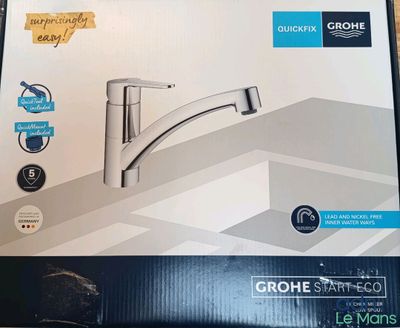 a box with a picture of a kitchen faucet in it