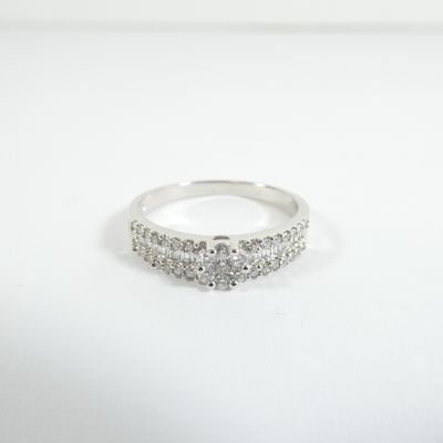 a close up of a diamond ring on a white surface