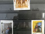 several stamps on display in a glass case in a museum