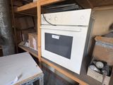 a white oven sitting on top of a shelf in a room