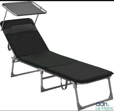 an image of a black lounger with a tray on top of it