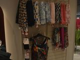 a picture of a clothing store with a rack of clothes
