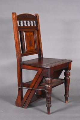 an old wooden chair sitting on top of a gray floor