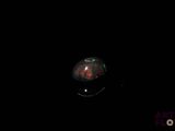 an image of a red and black object in the dark