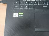 a close up of a laptop on a table with a cable