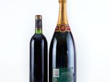 two bottles of wine sitting next to each other on a white surface