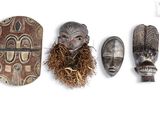 several african masks are lined up against a white background