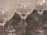 several empty wine glasses are lined up on a table