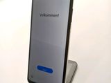 a phone that is sitting on a stand on a table