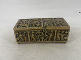 an antique brass box with carvings on it