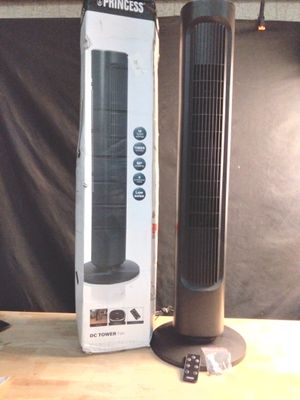 a black tower fan sitting next to a box on a table