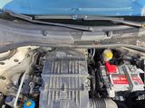 the engine of a car with its hood open and a battery in it