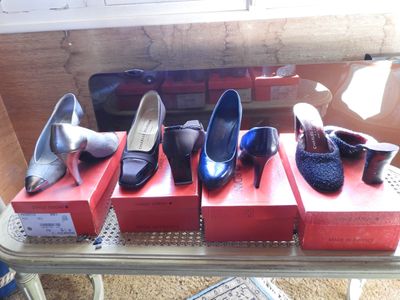 several pairs of women ' s shoes are on display on a table