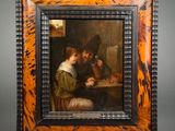painting of a man and a woman playing cards at a table