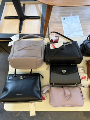 a lot of purses on a table in a store