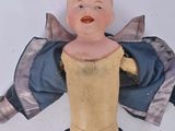 a small doll that has a jacket on it ' s back