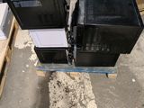 two televisions sitting on top of a pallet in a warehouse