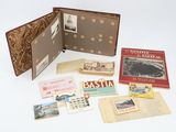 a lot of old books and postcards on the table