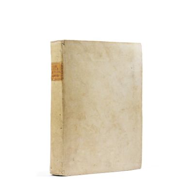 an old book sitting on top of a white table next to a white wall