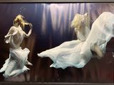 a picture of a woman in a white dress floating in the water