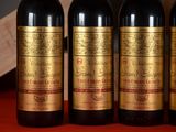 three bottles of wine sitting on top of a table next to a wooden box